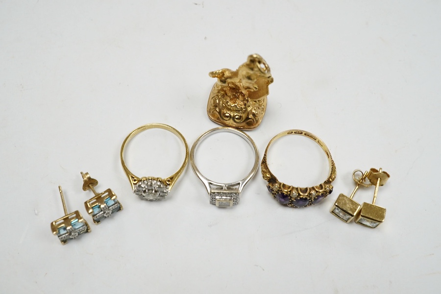 An 18ct and nine stone simulated diamond set cluster ring, a modern 18ct gold and diamond set square cluster ring, a Victorian 15ct gold, amethyst and seed pearl set half hoop ring, two pairs of 9ct and gem set ear studs